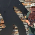 Festivalgoers at a Bigfoot-themed event in Marion, North Carolina, with a young contest winner