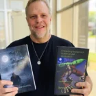 A Bigfoot-themed festival sign and a writer promoting books about Sasquatch in Owensboro