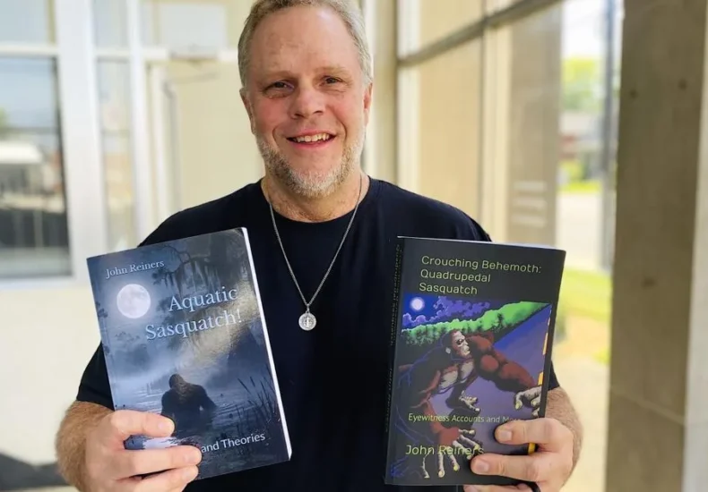 A Bigfoot-themed festival sign and a writer promoting books about Sasquatch in Owensboro