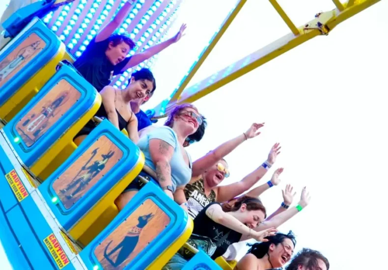 A Wave Swinger ride at the Tennessee State Fair with fairgoers nearby