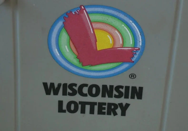Wisconsin Lottery jackpot tickets and a Powerball play slip on a counter