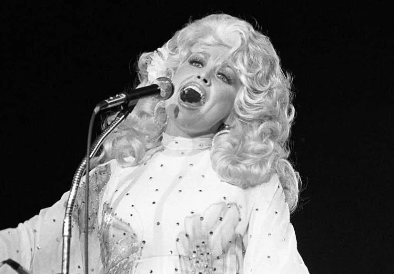 Dolly Parton performing at the Iowa State Fair Grandstand before a large crowd